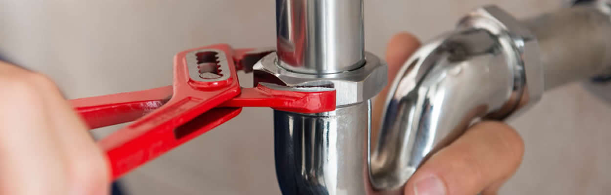 Plumber Using Wrench To Fix Sink Pipes Plumber Using Wrench To Fix Sink Pipes