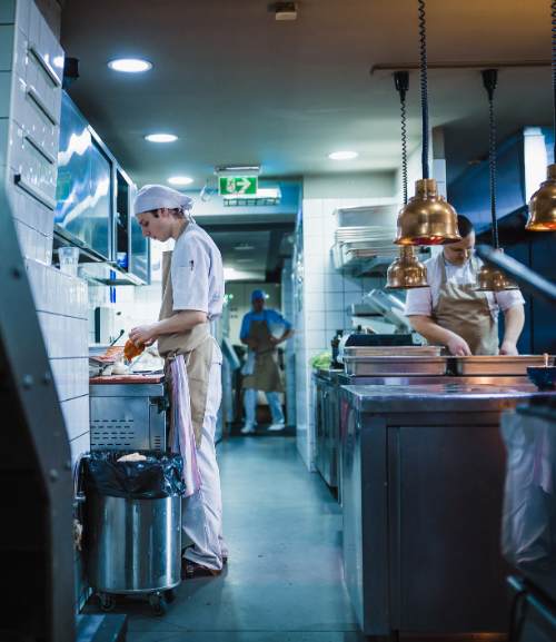 Employees Working In Restaurant Kitchen